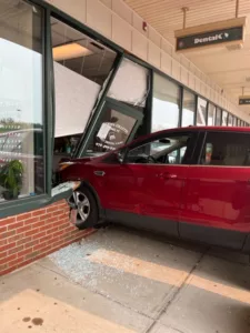 Red SUV crashed through the front of the brick facade and glass door of a dental office